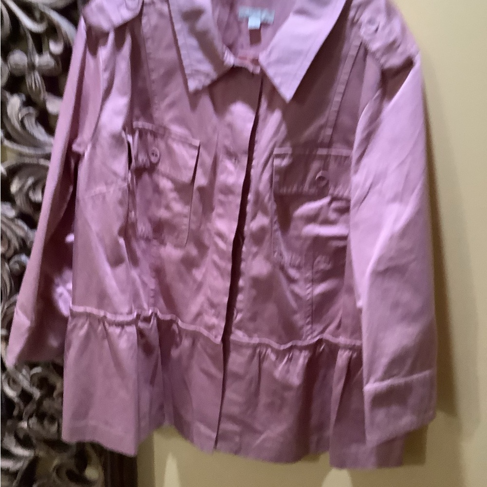 Womens lightweight jacket button front with two front pockets ruffle detail.